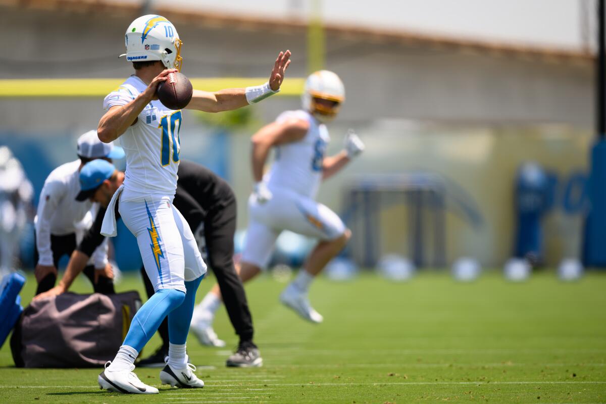 Chargers quarterback Justin Herbert finds a receiver downfield on a pass play during a minicamp drill on Tuesday.