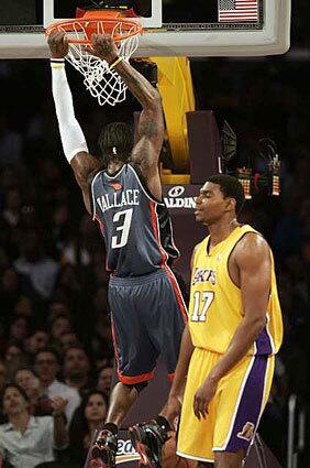 Charlotte Bobcats' Gerald Wallace scores over Lakers' center Andrew Bynum in the first half Tuesday night.