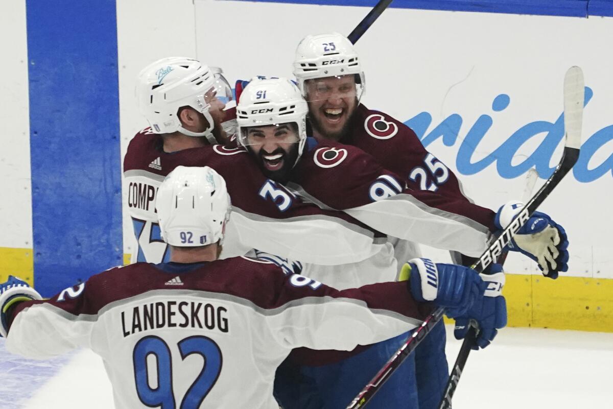 Colorado Avalanche center Nazem Kadri is congratulated by teammates after his overtime goal against the Tampa Bay Lightning.