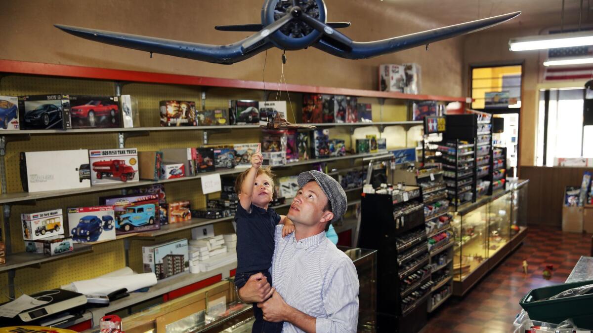 Colby Gomez, 2, and his dad, Tim Gomez, the great-grandson and grandson of Evett's Model Shop's owner.