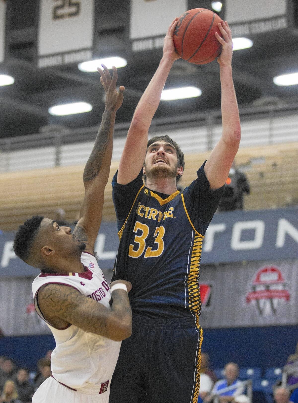 UC Irvine's Mike Best (33) scores against Boston College's Garland Owens.