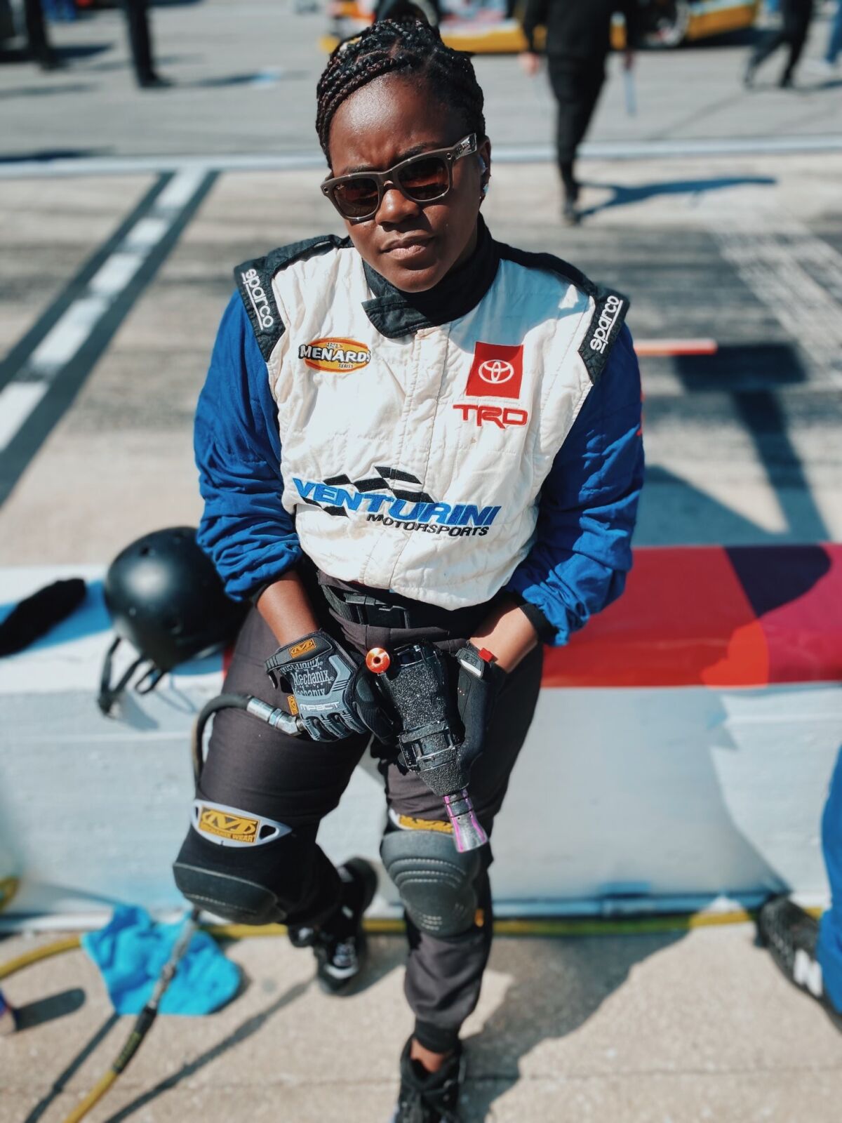 Trackhouse Racing tire changer Dalanda Ouendeno holds a wheel gun during a recent NASCAR race weekend.