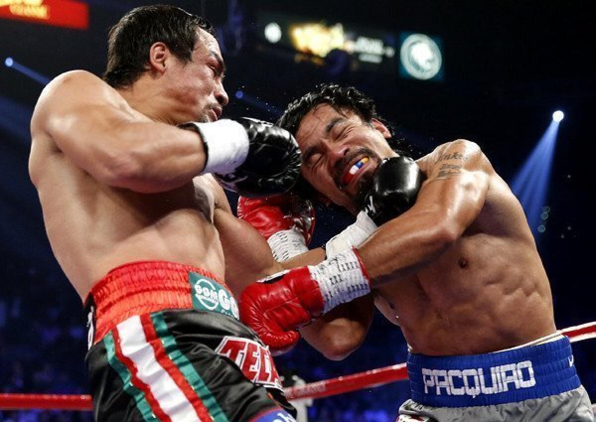 Juan Manuel Marquez lands a left against Manny Pacquiao during their welterweight fight on Saturday night at the MGM Grand Garden Arena in Las Vegas.