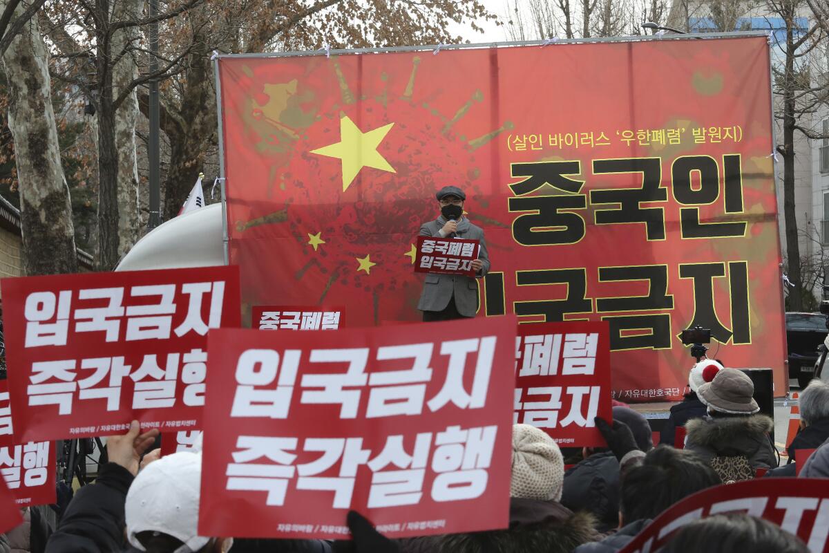 In this Wednesday, Jan. 29, 2020, photo, South Korean protesters stage a rally calling for a ban on Chinese people entering South Korea near the presidential Blue House in Seoul, South Korea. A scary new virus from China has spread around the world. So has rising anti-Chinese sentiment, calls for a full travel ban on Chinese visitors and indignities for Chinese and other Asians. The signs read: "No Entry." (AP Photo/Ahn Young-joon)