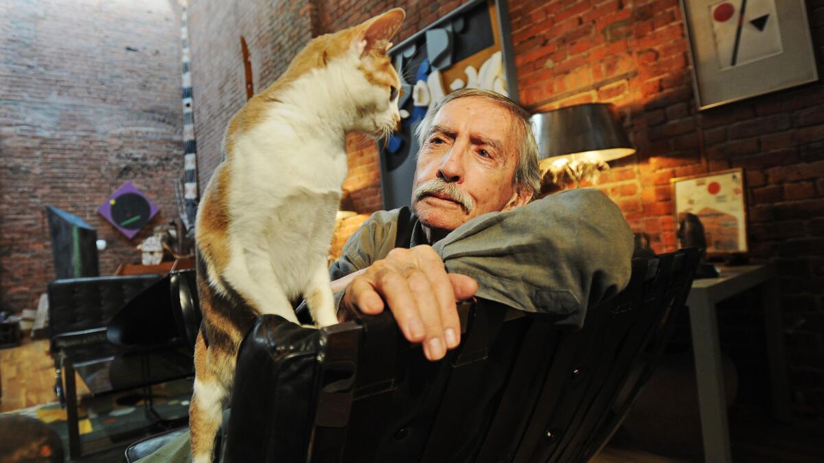 Albee at home with his cat.