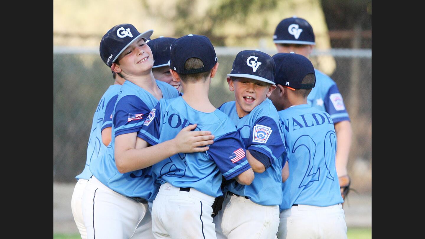 The 9-10 minor Crescenta Valley baseball team celebrates their championship win against Burbank in a Little League District 16 championship at Tujunga Little League Fields in Tujunga Friday, June 30, 2017. Crescenta Valley won the game 8-0.