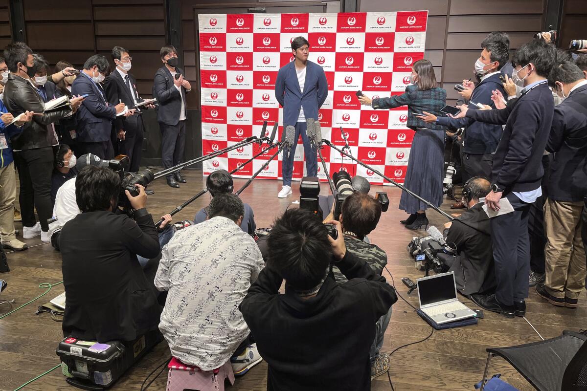 Angels' Shohei Ohtani speaks to reporters Tuesday at the Haneda international airport in Tokyo.