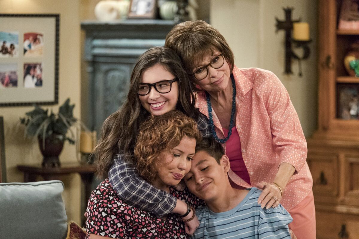 The cast of "One Day at a Time" embrace