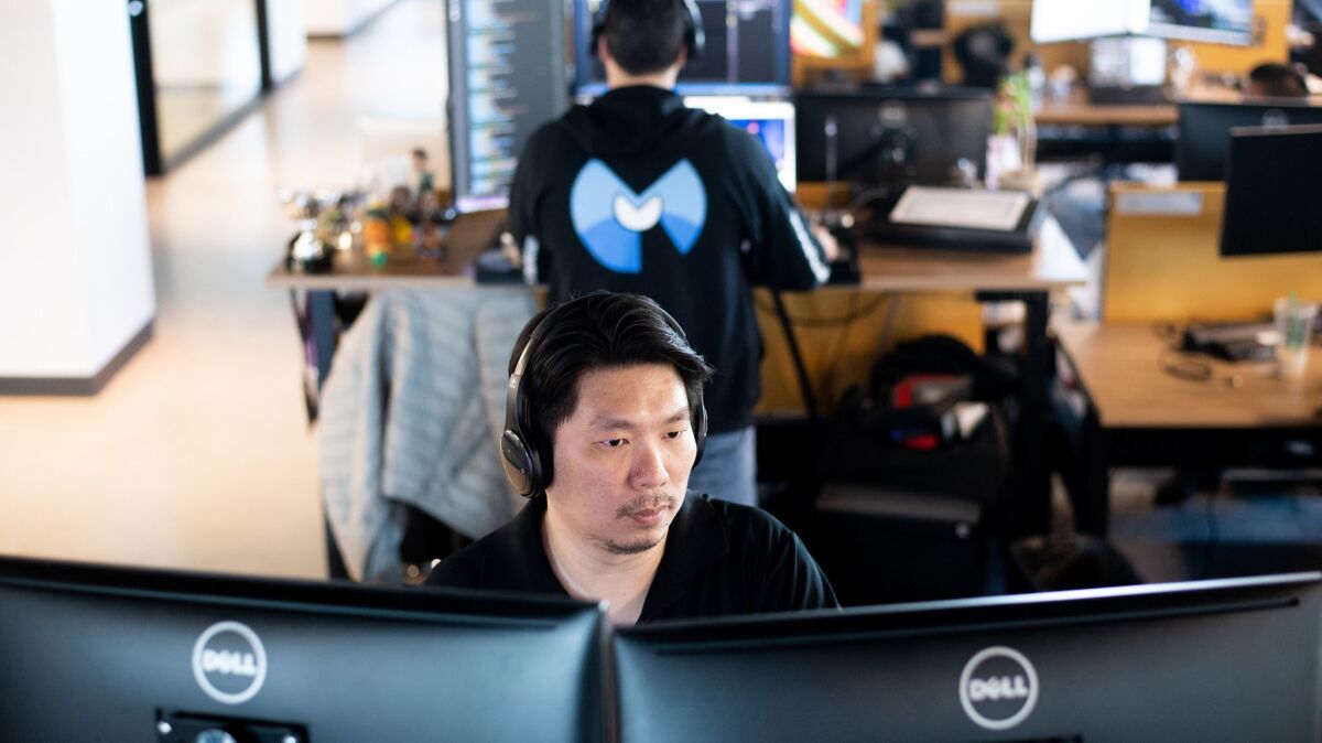 Malwarebytes quality assurance engineer Philip Lee takes a Udemy course at his desk on April 30 in Santa Clara, Calif.