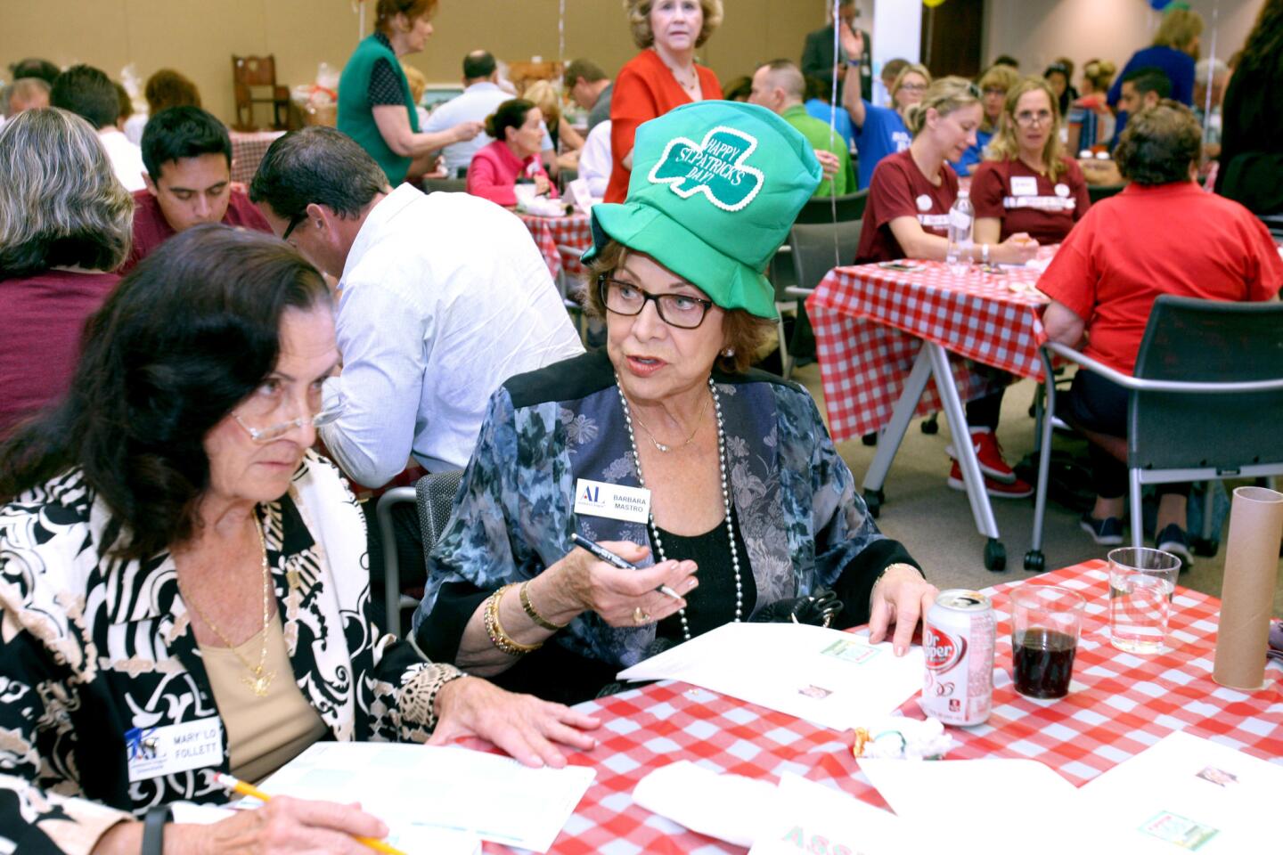 Mary Lo Follett, left, and Barbara Mastro from the Assistance League, work on the questions passed out to all participants at the 29th annual Smart-A-Thon.