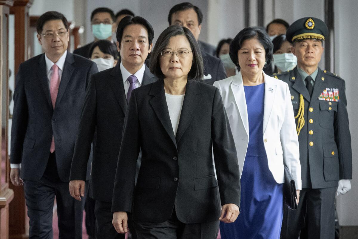 Taiwanese President Tsai Ing-wen, center, walks with other officials.