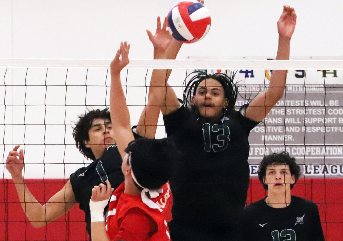 Sage Hill's Connor Gapp (1) and Tre Cradle (13) block Fullerton's Hyunmin Kim (11) on Thursday.