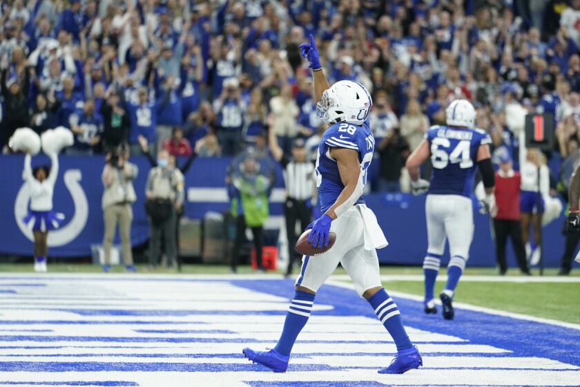 Indianapolis Colts' Jonathan Taylor (28) reacts after rushing for a touchdown during the second half of an NFL football game against the Tampa Bay Buccaneers, Sunday, Nov. 28, 2021, in Indianapolis. (AP Photo/Michael Conroy)
