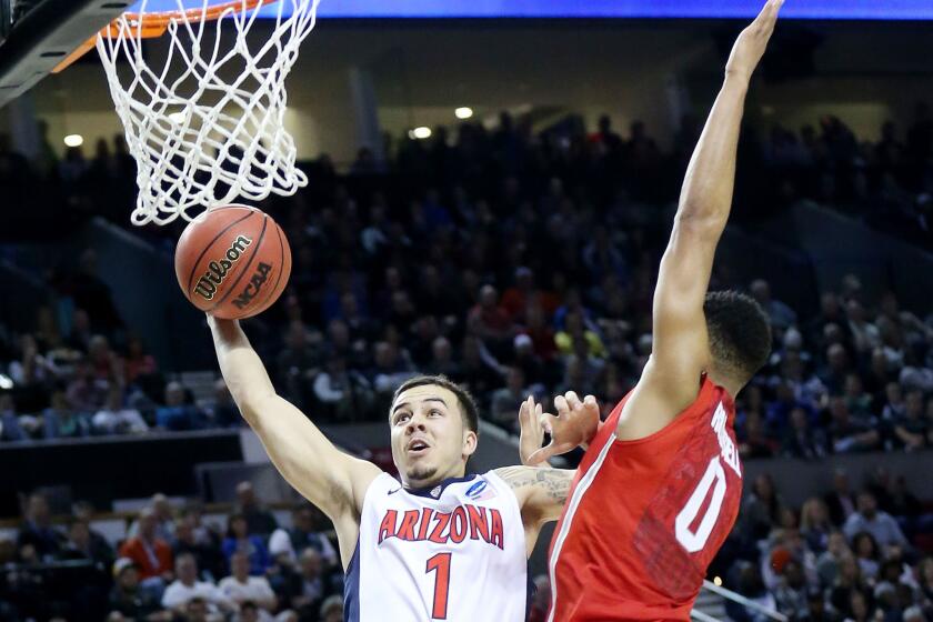 Arizona guard Gabe York goes up against Ohio State point guard D'Angelo Russell during the second half of their third-round matchup in the NCAA tournament.
