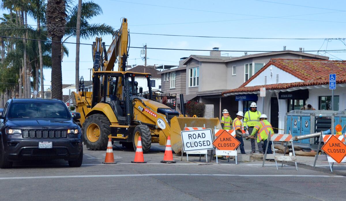 Crews work on Balboa Island Park Avenue, which is closed to cars heading west.