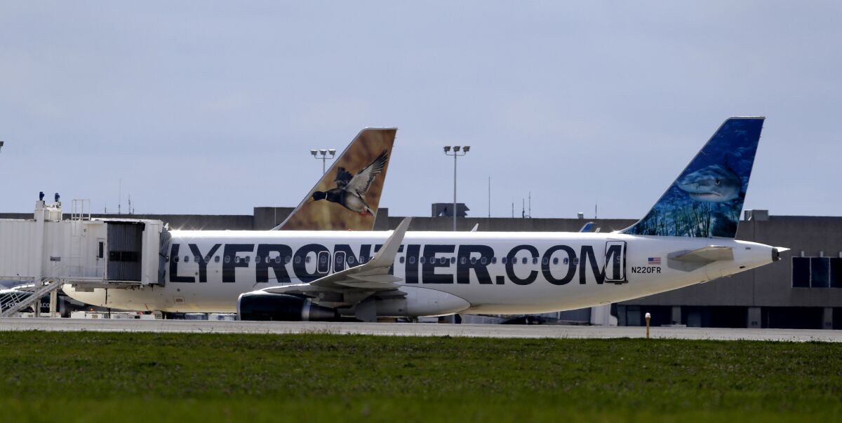 The Frontier Airlines plane that Amber Vinson flew from Cleveland to Dallas on Monday, rests at a terminal at Cleveland Hopkins International Airport, Wednesday, Oct. 15. The carrier is working with federal health officials to contact passengers who flew with an Ebola-stricken healthcare worker this week.