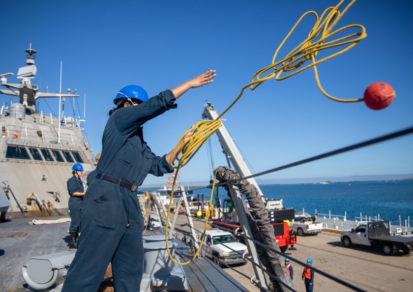Sailors work aboard the USS Milwaukee as it arrives at Naval Station Guantánamo Bay on Dec. 20.