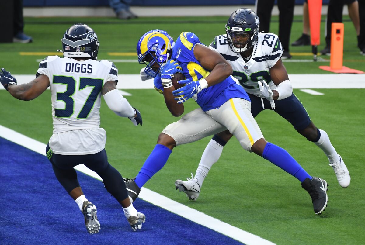 Rams running back Malcolm Brown scores a touchdown between Seahawk defenders Quandre Diggs and D.J. Reed.