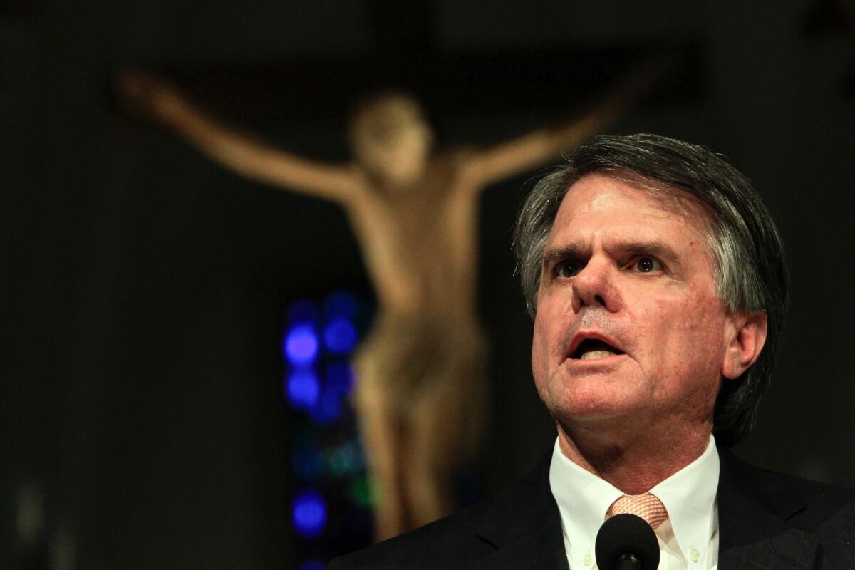 Loyola Marymount University President David W. Burcham, here speaking at a campus chapel, is resigning in May after five years in the post.