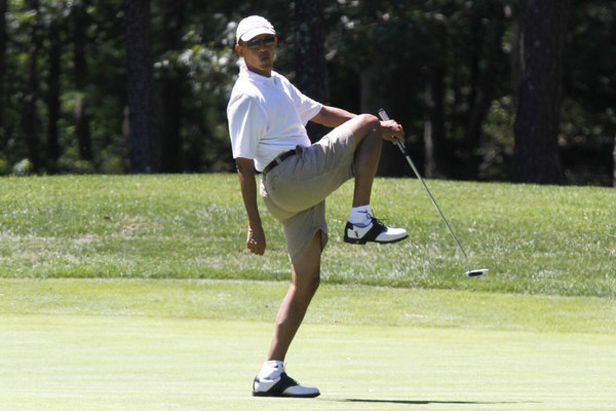 President Obama reacts as he misses a shot while golfing this summer at Farm Neck Golf Club in Oak Bluffs, Mass. Obama is well known as an avid golfer and basketball player, but his football analogy in discussing his healthcare plan seemed an odd choice.