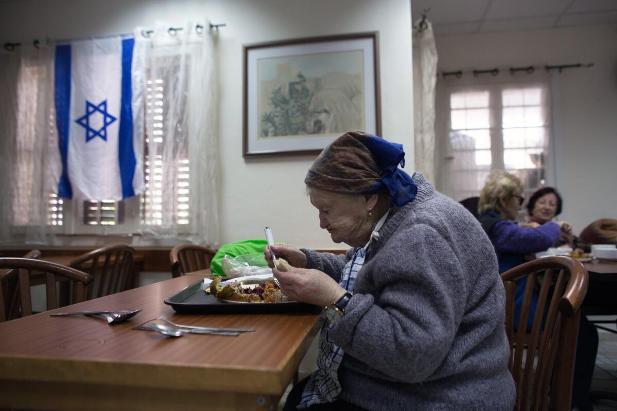 Holocaust survivors eat in the shared dining room of a facility that serves them in the northern Israeli port city of Haifa on Jan. 21.