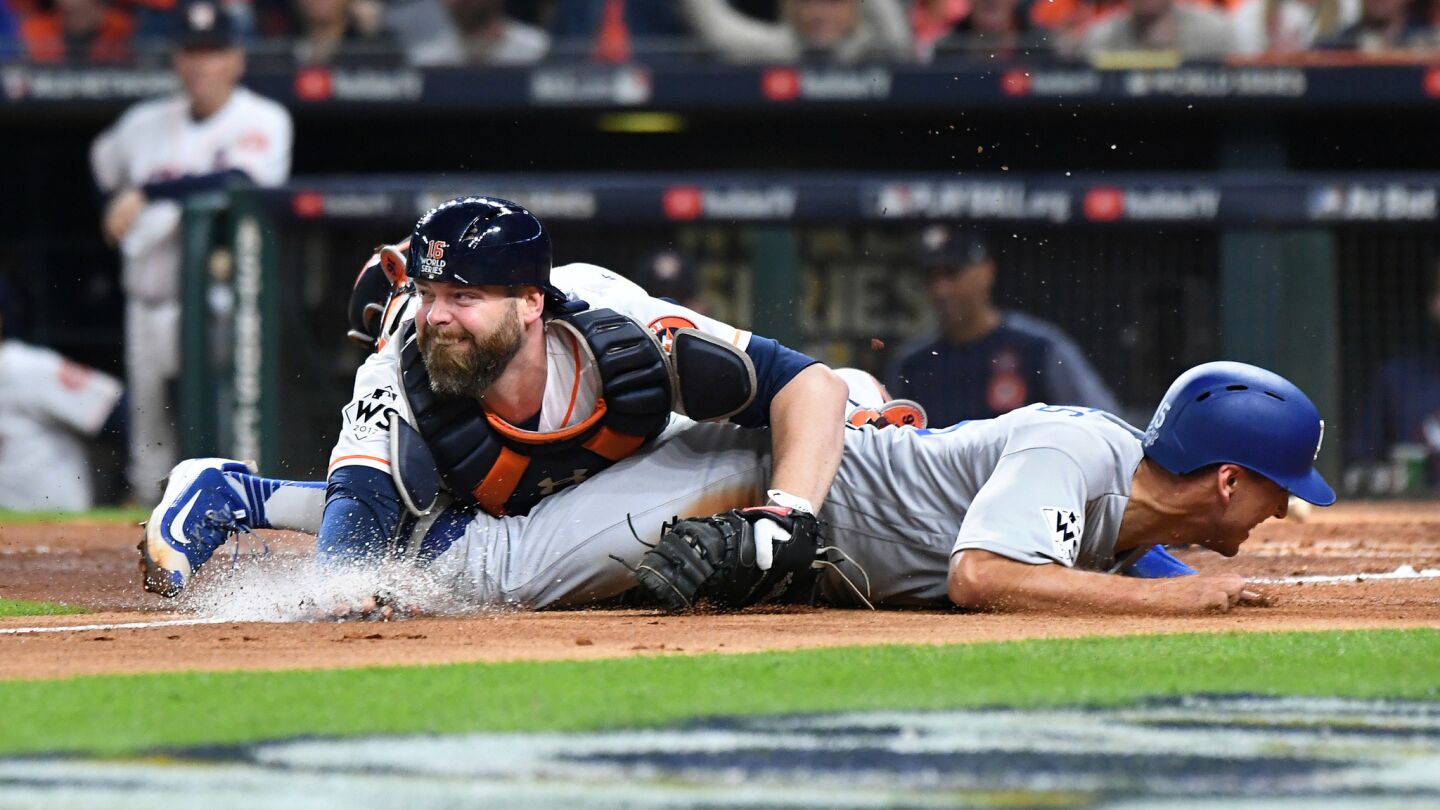 Austin Barnes is tagged out by Astros catcher Brian McCann while trying to score from third base in the sixth inning.