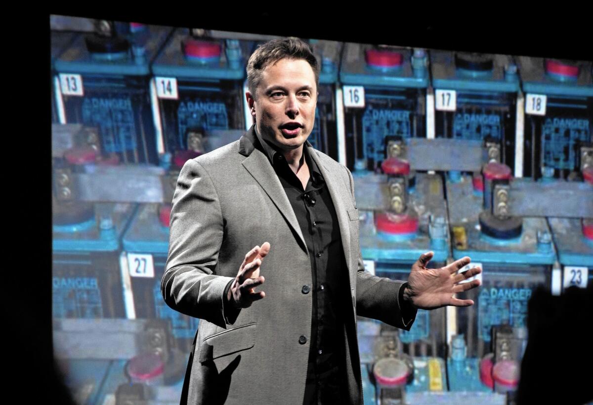 The Irvine Co. plans to install battery-powered energy systems that would use batteries purchased from Elon Musk’s Tesla. Above, Musk unveils a new line of residential and commerical batteries in April.
