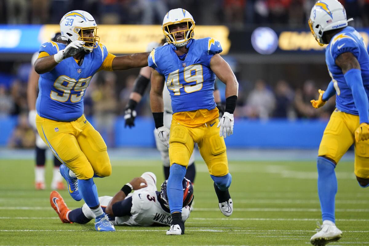 Chargers linebacker Drue Tranquill (49) celebrates his sack of Broncos quarterback Russell Wilson.