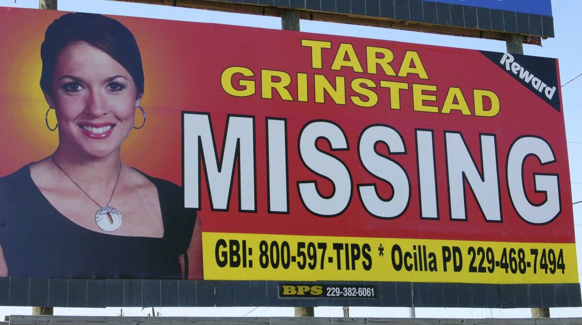 FILE - An image of Tara Grinstead is displayed on a billboard in Ocilla, Ga. Ryan Duke, charged with murdering Grinstead, a popular high school teacher who vanished in 2005, went on trial Monday, May 9, 2022, with prosecutors and defense attorneys clashing over whether the jury should believe the defendant's confession to investigators. (AP Photo/Elliott Minor, File)