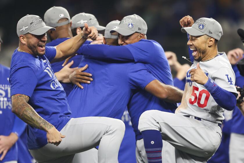 Dodgers' Mookie Betts, right, celebrates after the Dodgers clinched the NL West title on Sept. 16, 2023, in Seattle.