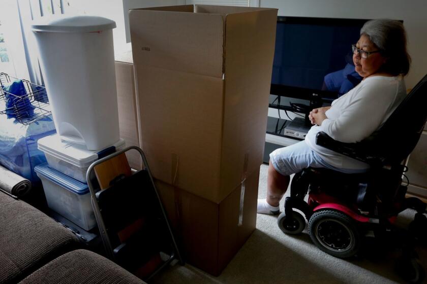 RANCHO SANTA MARGARITA , CA., JANUARY 22, 2016: Joann Hesson, 67, sits among her moving boxes and personal belongings in a small apartment in Rancho Santa Margarita January 2016. Hessson, a Marine Corps Veteran, and retired paralegal took out several high-interest installment loans to pay her mounting medical bills and is now filing for bankruptcy and moving closer to her family (Mark Boster / Los Angeles Times ).