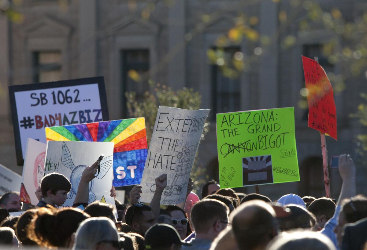 Protesters gather at the Arizona state Capitol in opposition to a bill that would allow businesses to use religious liberty as grounds for denying gays and lesbians service.