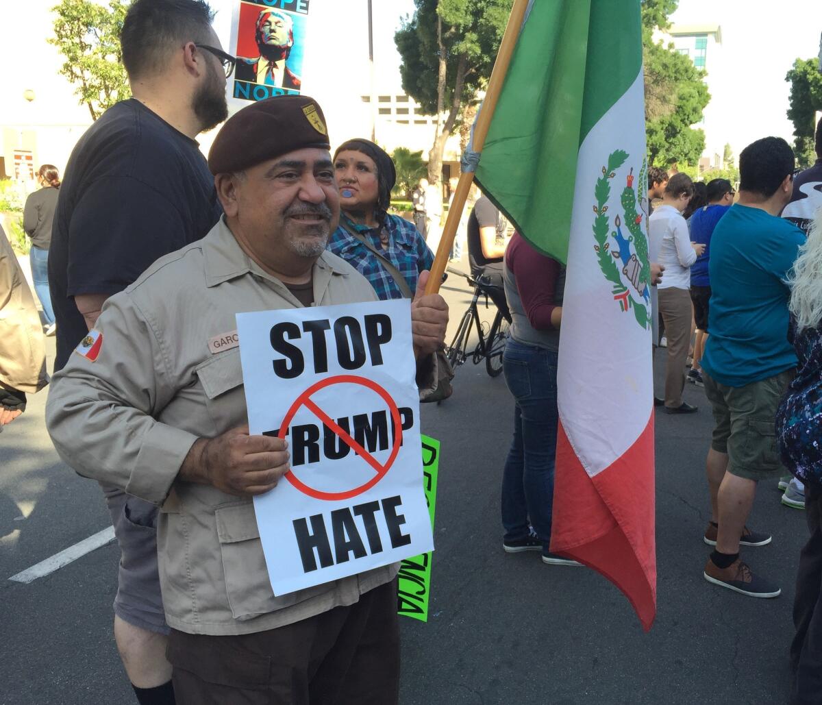 Paul Garcia, toting a Mexican flag, and an anti-Trump sign, shows his displeasure with Donald Trump at a protest in Fresno.