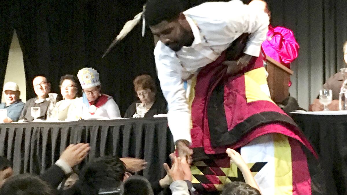 Celtics star Kyrie Irving accepts gifts from students on the Standing Rock Indian Reservation in North Dakota on Thursday.