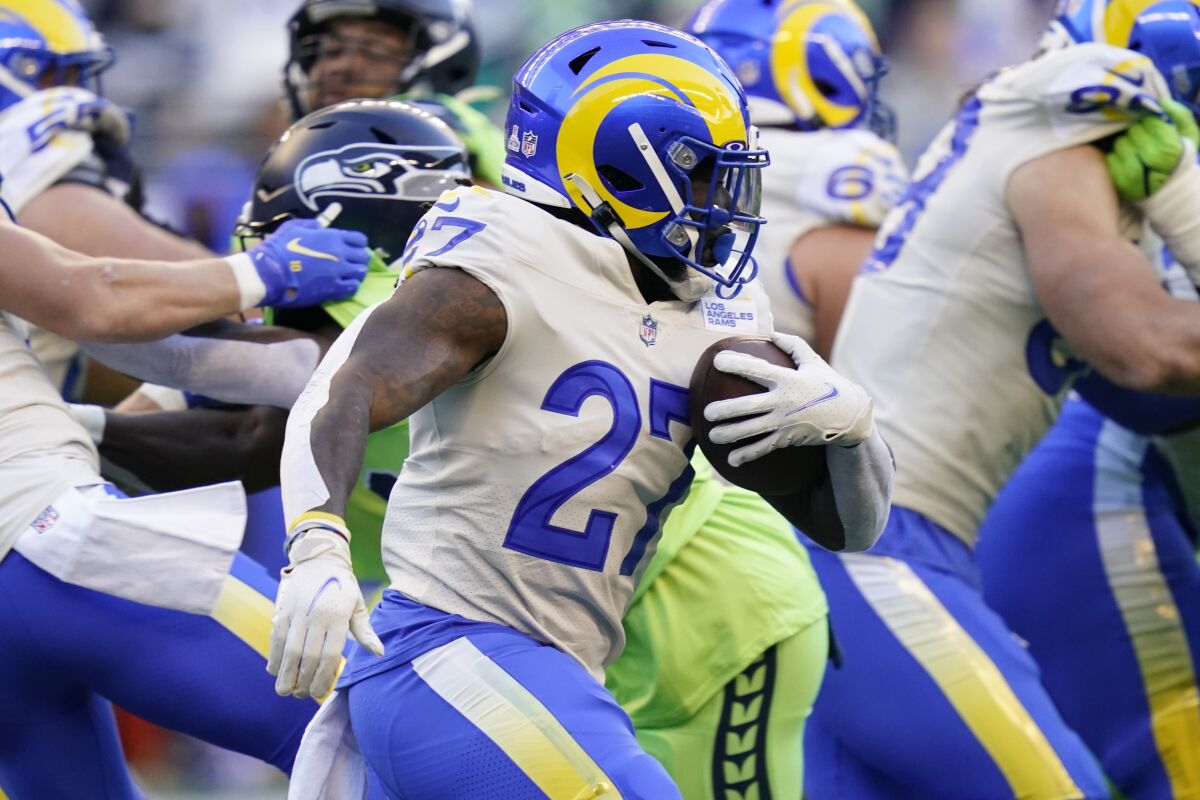 Rams running back Darrell Henderson carries the ball against the Seattle Seahawks during the first half.