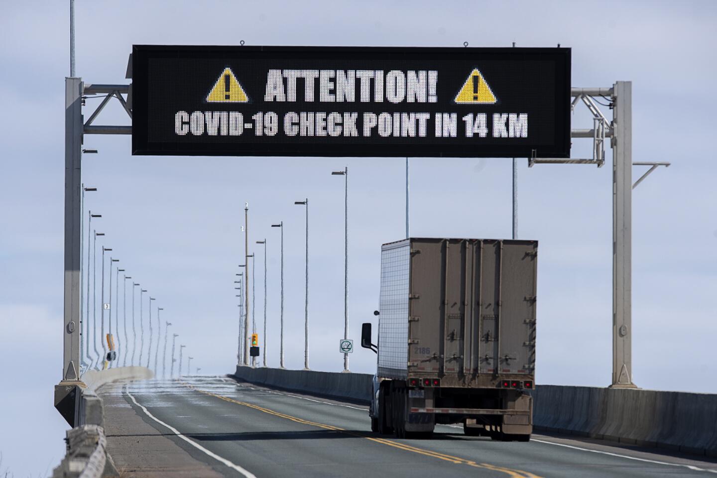 Canada: A sign indicates that provincial health department workers will stop traffic that has crossed the Confederation Bridge in Cape Jourimain, New Brunswick, Canada.