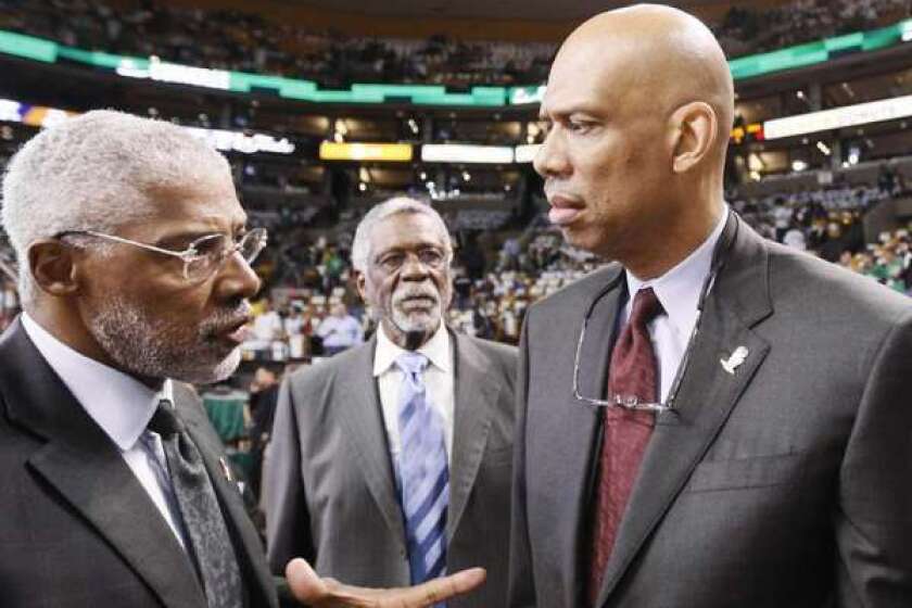 Julius Erving, left, might be a fan of Bill Russell, center, and Kareem Abdul-Jabbar, but he doesn't trust their old teams, the Celtics and the Lakers.