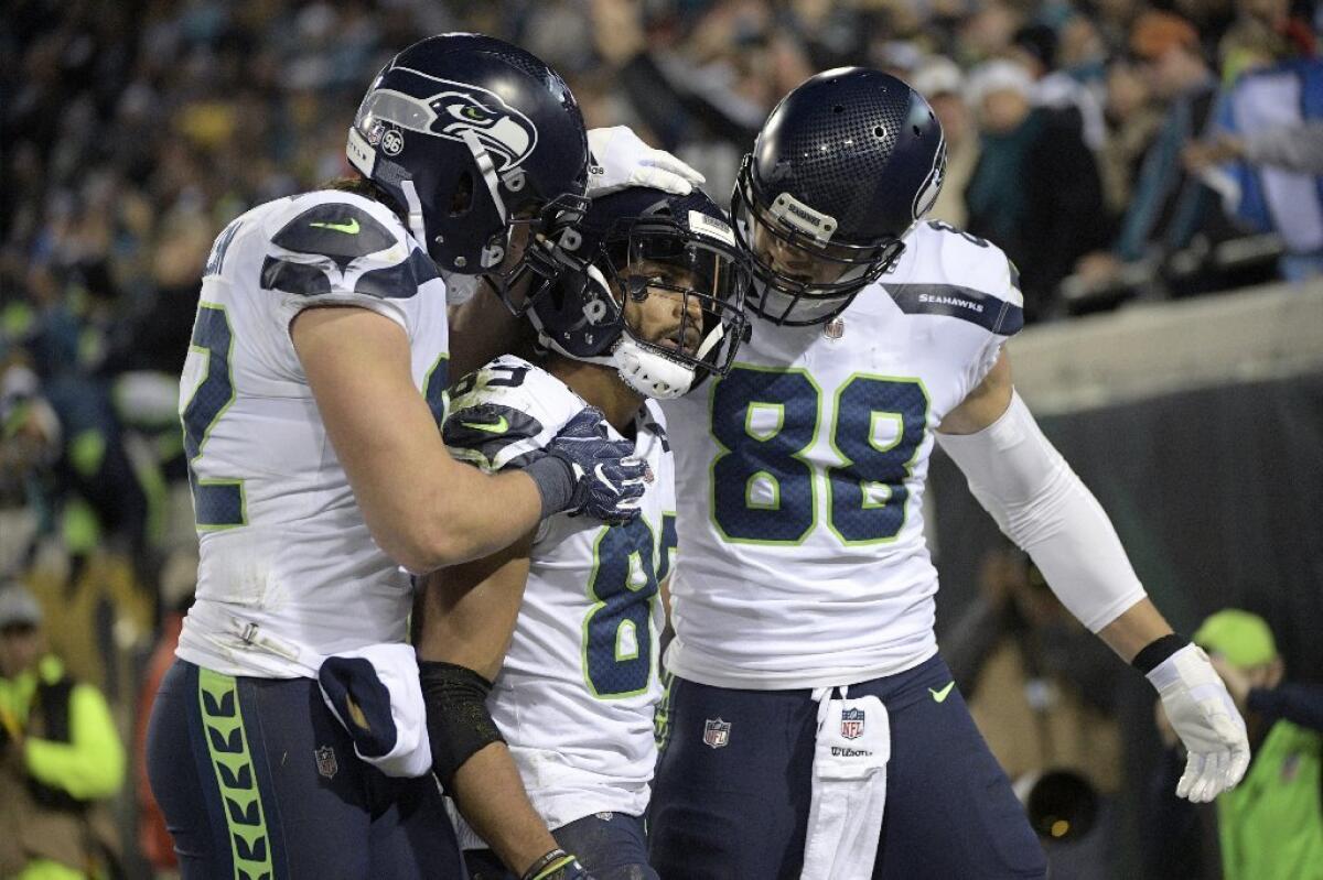 Seahawks receiver Doug Baldwin, center, is congratulated by his teammates after a touchdown reception against the Jaguars on Dec. 10.
