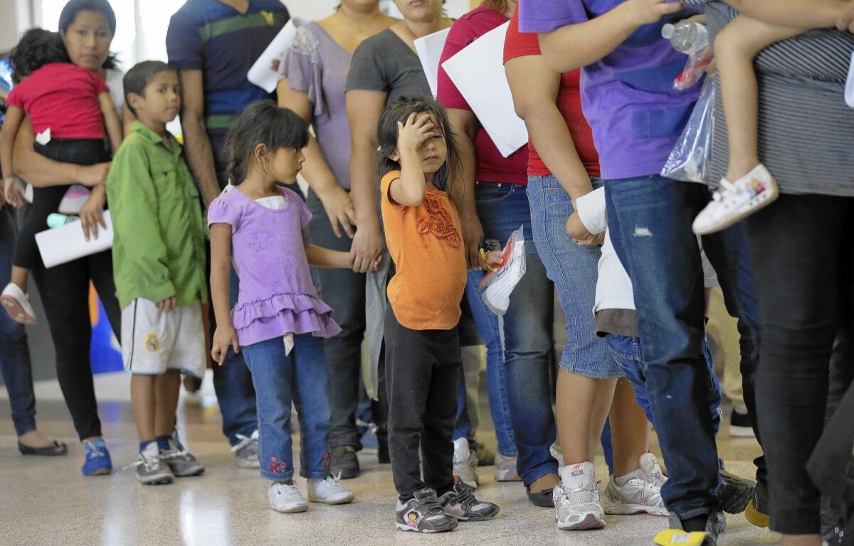 Immigrants who entered the U.S. illegally stand in line for tickets at a bus station after they were released from a U.S. Customs and Border Protection processing facility in McAllen, Texas.