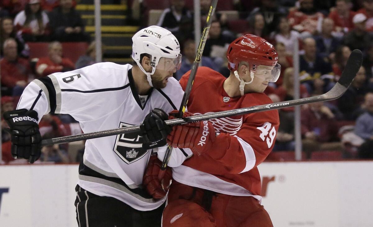 The Kings' Jame Muzzin ties up Red Wings forward Andrej Nestrasil during the second period of Los Angeles' 5-2 loss to Detroit on Oct. 31.
