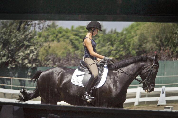 Rison Naness rides on one of her favorite horses, Kantor, at Paddock Riding Club in Los Angeles on Thursday, August 17, 2011. Naness has been riding since she was five-years-old. She will be competing in the Dressage Equitation Finals next week in Chicago.