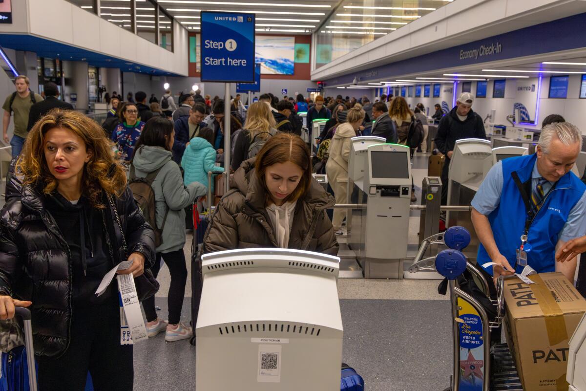 People in line at an airport security checkpoint. 