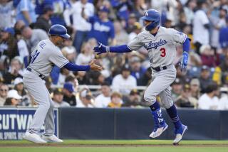 Dodgers' Chris Taylor (3) is greeted by third base coach Dino Ebel after hitting a two-run home run 