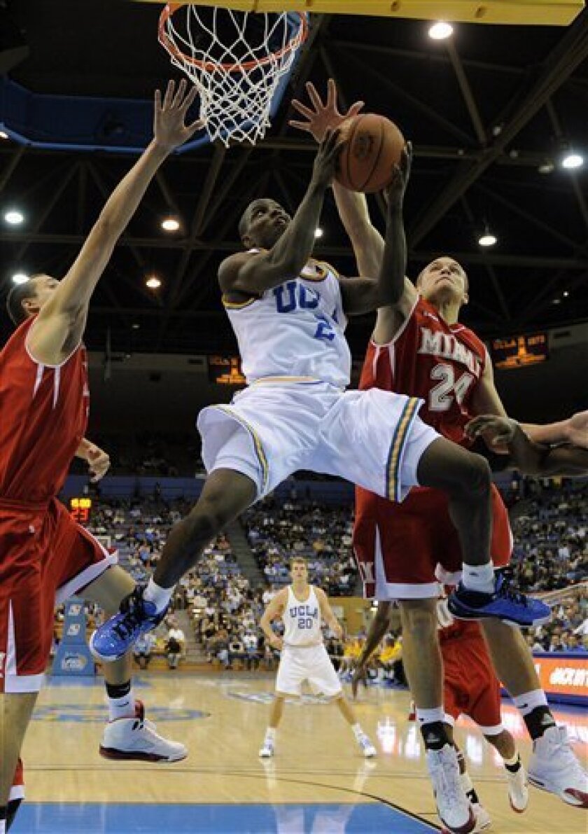 UCLA's Darren Collison goes up for a shot as Miami of Ohio's Tyler Dierkers, left, and Michael Bramos, right, defend during the first half of their NCAA college basketball game at the 2K Sports Classic, Thursday, Nov. 13, 2008, in Los Angeles. (AP Photo/Mark J. Terrill)