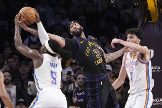Oklahoma City Thunder guard Luguentz Dort, left, and Los Angeles Lakers forward Anthony Davis, center, each for a rebound as forward Chet Holmgren stands by during the second half of an NBA basketball game Monday, Jan. 15, 2024, in Los Angeles. (AP Photo/Mark J. Terrill)