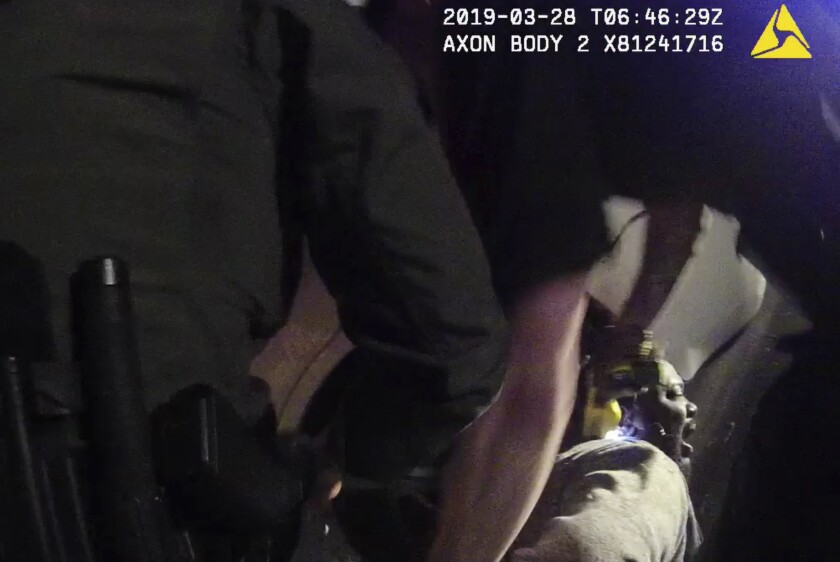 FILE - In this file image made from a March 28, 2019, body-worn camera video provided by the Austin Police Department in Texas, Williamson County deputies hold down Javier Ambler as one of them uses a Taser on Ambler's back during his arrest. Ambler, a Black man, died in custody in 2019 after sheriff's deputies repeatedly used stun guns on him, despite his pleas that he was sick and couldn't breathe, according a report published Monday, June 8, 2020, by the Austin American-Statesman and KVUE-TV. The video was made on the camera worn by an Austin police officer who also showed up at the scene as Williamson County deputies were making the arrest. Commissioners in suburban Williamson County have approved a $5 million wrongful death lawsuit settlement with the family of Ambler. (Austin Police Department via AP, File)