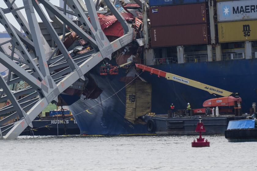 Workers remove wreckage of the collapsed Francis Scott Key Bridge, Thursday, April 25, 2024, in Baltimore. (AP Photo/Matt Rourke)