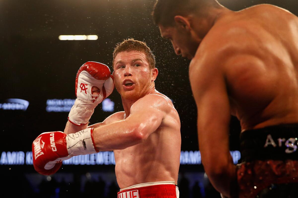 Canelo Alvarez throws a left at Amir Khan at T-Mobile Arena on May 7.