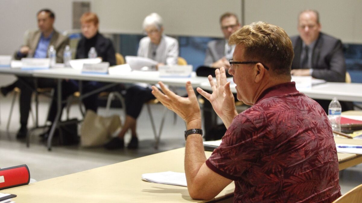 Board member Doug Case speaks during a meeting of the Community Review Board on Police Practices in September.