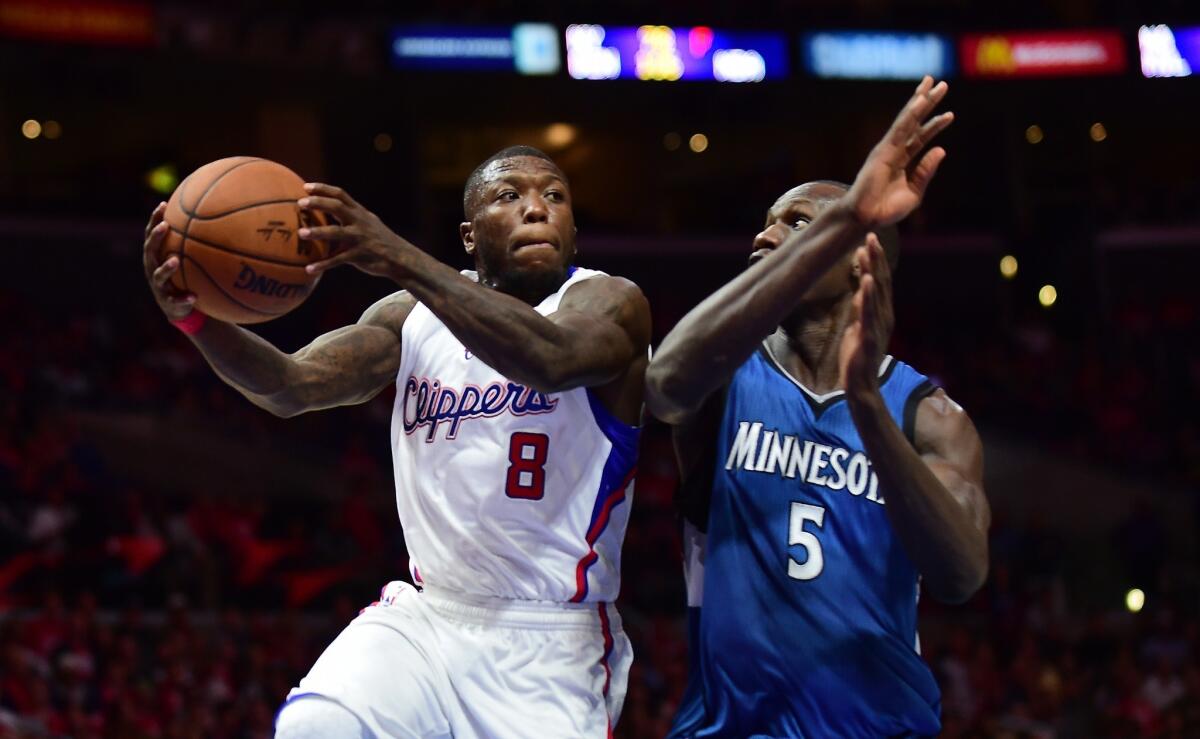 Nate Robinson looks to pass under pressure from Minnesota's Gorgui Dieng on March 9.
